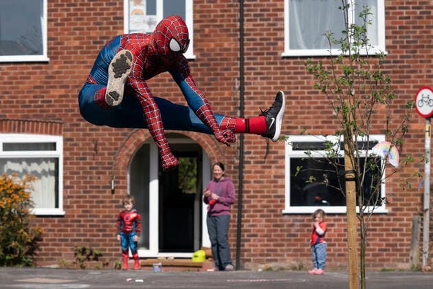 (200414) -- MANCHESTER, April 14, 2020 (Xinhua) -- Jason Baird, who runs a martial arts academy in South Manchester, dressed up as Spider-Man, entertains the public amid the COVID-19 outbreak in Manchester, Britain on April 13, 2020. (Photo by Jon Super Xinhua) BRITAIN-MANCHESTER-COVID-19-SPIDER-MAN 