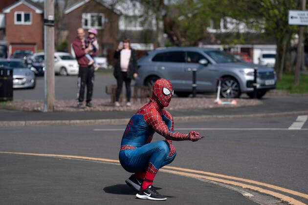 (200414) -- MANCHESTER, April 14, 2020 (Xinhua) -- Jason Baird, who runs a martial arts academy in South Manchester, dressed up as Spider-Man, entertains the public amid the COVID-19 outbreak in Manchester, Britain on April 13, 2020. (Photo by Jon Super Xinhua) BRITAIN-MANCHESTER-COVID-19-SPIDER-MAN 