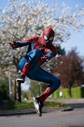 (200414) -- MANCHESTER, April 14, 2020 (Xinhua) -- Jason Baird, who runs a martial arts academy in South Manchester, dressed up as Spider-Man, entertains the public amid the COVID-19 outbreak in Manchester, Britain on April 13, 2020. (Photo by Jon Super Xinhua) BRITAIN-MANCHESTER-COVID-19-SPIDER-MAN 
