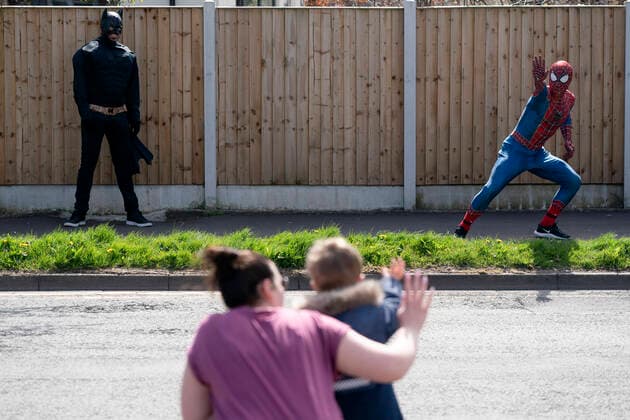 (200414) -- MANCHESTER, April 14, 2020 (Xinhua) -- Jason Baird, who runs a martial arts academy in South Manchester, dressed up as Spider-Man, entertains the public amid the COVID-19 outbreak in Manchester, Britain on April 13, 2020. (Photo by Jon Super Xinhua) BRITAIN-MANCHESTER-COVID-19-SPIDER-MAN 