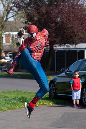 (200414) -- MANCHESTER, April 14, 2020 (Xinhua) -- Jason Baird, who runs a martial arts academy in South Manchester, dressed up as Spider-Man, entertains the public amid the COVID-19 outbreak in Manchester, Britain on April 13, 2020. (Photo by Jon Super Xinhua) BRITAIN-MANCHESTER-COVID-19-SPIDER-MAN 