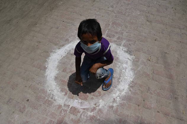 April 14, 2020, Prayagraj, Uttar Pradesh, India: Prayagraj: A child sit in a circle while in queue to take free food outside Ishwar Sharan college community kitchen during a nationwide lockdown government-imposed nationwide lockdown as a preventive measure against the COVID-19 coronavirus, in Allahabad on Tuesday, April 14, 2020. Prayagraj India - ZUMAv115 20200414_zap_v115_012 Copyright: xPrabhatxKumarxVermax
