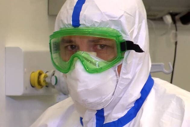 LOMBARDY, ITALY â€“ APRIL 14, 2020: A video screen grab shows a staff member at work in a field hospital in Bergamo where Russian medics join their Italian counterparts in treating coronavirus patients, 31 of them already admitted, eight cured of the COVID-19 infection. Best quality available. Russian Defence Ministry TASS  TS0D59D7