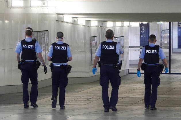 A group of police officers rush to an operation at Würzburg central station, Bavaria, Germany