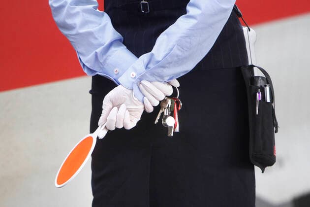 Train attendant of DB Deutsche n Bahn AG wears disposable gloves during the train handling of an ICE in the main station Mannheim, Baden Württemberg, Germany