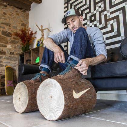 A quirky artist has created the ultimate footwear to make you stay at home during the current coronavirus crisis sneakers made of logs. French artist Monsieur Plant is known for making artworks from real plants and natural materials. He says he has isolated himself in his Brittany workshop to get closer to nature. His newly-created ?Stay Calm? shoes meld a sneaker with a log and add a cheeky Nike-inspired ?swoosh? logo. Monsieur Plant says he has chosen to translate this confinement in a quirky and humorous way as opposed to the media coverage of the Coronavirus COVID-19 . He explains: In the current situation, humanity is undergoing an unprecedented health crisis forcing us to be confined in order to limit the spread of the disease. I imagined sneakers that force us to stay at home. Working mainly with natural p Copyright: xx 40445171 EDITORIAL USE ONLY. NOT FOR USE BY NEWSPAPERS BASED IN THE UK.