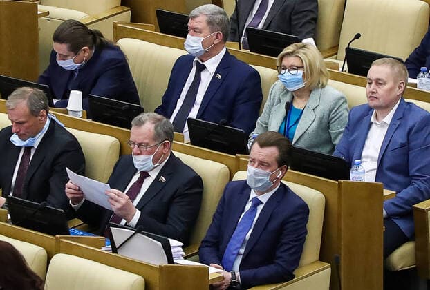 MOSCOW, RUSSIA - APRIL 14, 2020: Russian State Duma members wear face masks during a plenary meeting. Anton Novoderezhkin TASS  TS0D5A3D