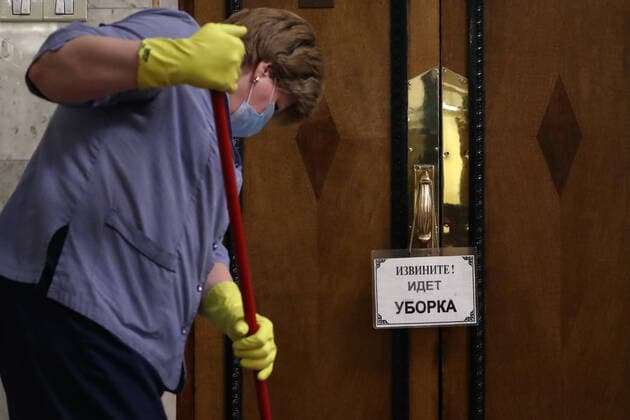MOSCOW, RUSSIA - APRIL 14, 2020: A woman washes the floor at the Russian State Duma. Anton Novoderezhkin TASS  TS0D5A91