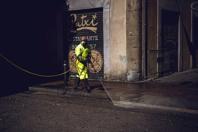 April 14, 2020, Barcelona, Catalonia, Spain: An employee of the municipal cleaning service cleans the street with a high-pressure cleaner in Barcelona at the end of the first month of a nationwide lockdown due to the continuous spread of COVID-19. Spain registered 300 new fatalities totaling a death toll of over 18000 so far. Barcelona Spain - ZUMAo105 20200414_zap_o105_002 Copyright: xMatthiasxOesterlex