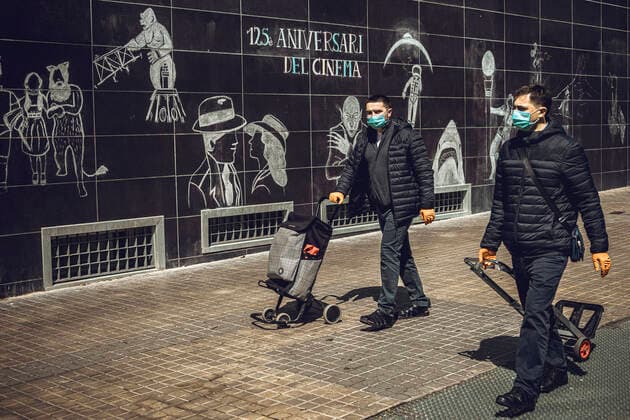 April 14, 2020, Barcelona, Catalonia, Spain: Two men wearing a protective face mask in Barcelona after coronavirus restrictions have been eased for non-essential workers at the end of the first month of a nationwide lockdown due to the continuous spread of COVID-19. Spain registered 300 new fatalities totaling a death toll of over 18000 so far. Barcelona Spain - ZUMAo105 20200414_zap_o105_011 Copyright: xMatthiasxOesterlex