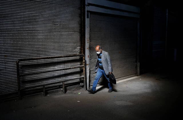 (200414) -- TEHRAN, April 14, 2020 -- A man walks past closed shops at the Grand Bazaar in Tehran, Iran, on April 13, 2020. (Photo by Xinhua) IRAN-TEHRAN-COVID-19-GRAND BAZAAR AhmadxHalabisaz 