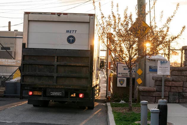 NYC buries unclaimed COVID-19 bodies on Hart Island Medical Examiner refrigerated truck loaded on ferry from City Island to Hart Island where unclaimed COVID-19 bodies are buried New York New York United States Copyright: LevxRadin