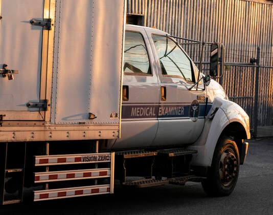 NYC buries unclaimed COVID-19 bodies on Hart Island New York, NY - April 14, 2020: Medical Examiner refrigerated truck seen before loaded on ferry from City Island to Hart Island where unclaimed COVID-19 bodies are buried New York New York United States Copyright: LevxRadin