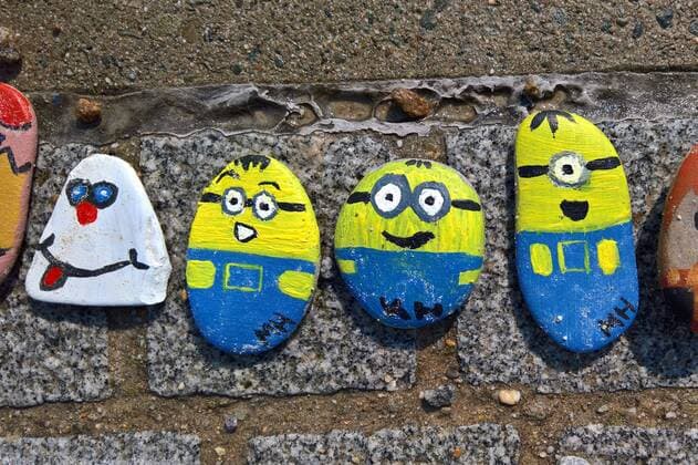 In Regensburg children paint pebbles and lay them on the ground along the Danube near Schwabelweis After the Corona Pandemic people are allowed to help themselves and take their favourites home with them Photo Painted Stones Minions