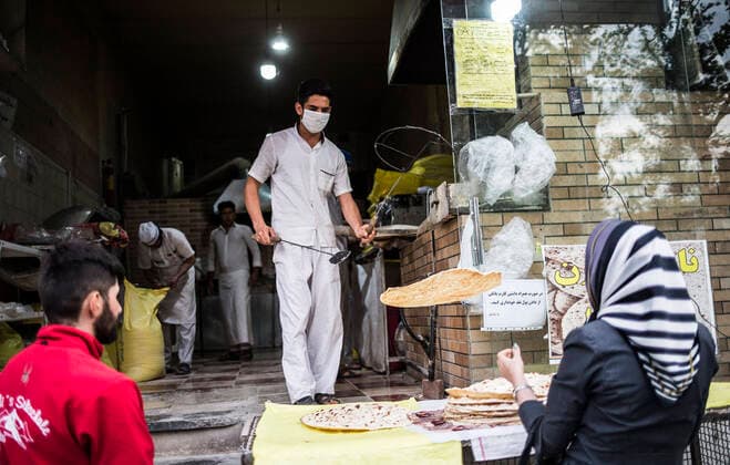 (200414) -- TEHRAN, April 14, 2020 -- A baker wearing face mask works at a bakery in Tehran, Iran, April 13, 2020. Iran registered 1,574 new COVID-19 cases over the past 24 hours, bringing the total number of confirmed cases to 74,877, according to Iran s health ministry on Tuesday. (Photo by Xinhua) IRAN-TEHRAN-COVID-19-CASES AhmadxHalabisaz 