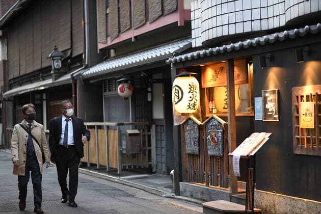 KYOTO, JAPAN - APRIL 14: Men with face mask walks near a restaurant in an almost empty street in Kyoto amid the coronavirus pandemic on April 14, 2020. The government of Japan has requested that businesses including schools, athletic facilities, bars and restaurants to temporarily close or operate under reduced hours. Japanese Prime Minister Shinzo Abe declared a state of emergency last week for Tokyo and six other prefectures including Kyoto to ramp up defenses against the spread of the coronavirus. (Photo: Richard Atrero de Guzman AFLO)  (125331777)