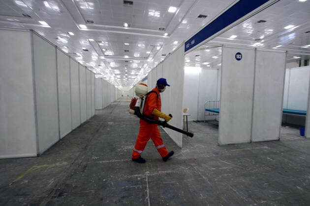 (200414) -- CHENNAI, April 14, 2020 (Xinhua) -- A municipal worker sprays disinfectant at a makeshift isolation hospital for COVID-19 patients in Chennai, India, April 14, 2020. India s health ministry Tuesday evening said the death toll due to COVID-19 in India has risen to 353 and the total number of confirmed cases in the country reached 10,815. (Str Xinhua) INDIA-CHENNAI-CORONAVIRUS 