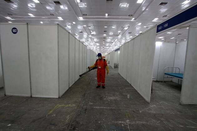 (200414) -- CHENNAI, April 14, 2020 (Xinhua) -- A municipal worker sprays disinfectant at a makeshift isolation hospital for COVID-19 patients in Chennai, India, April 14, 2020. India s health ministry Tuesday evening said the death toll due to COVID-19 in India has risen to 353 and the total number of confirmed cases in the country reached 10,815. (Str Xinhua) INDIA-CHENNAI-CORONAVIRUS 