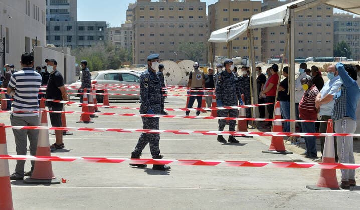 (200414) -- AHMADI GOVERNORATE, April 14, 2020 (Xinhua) -- Residents queue up to enter a new store for shopping in Mahboula area of Ahmadi Governorate, Kuwait, April 14, 2020. Kuwait opened on Tuesday a grocery store for residents of Mahboula area which is under lockdown due to the coronavirus. (Str Xinhua) KUWAIT-AHMADI GOVERNORATE-CORONAVIRUS-NEW STORE-OPENING 