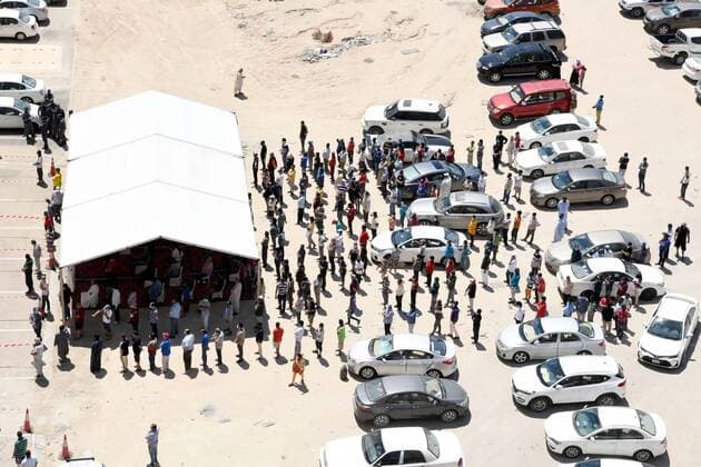 (200414) -- AHMADI GOVERNORATE, April 14, 2020 (Xinhua) -- Residents queue up to enter a new store for shopping in Mahboula area of Ahmadi Governorate, Kuwait, April 14, 2020. Kuwait opened on Tuesday a grocery store for residents of Mahboula area which is under lockdown due to the coronavirus. (Str Xinhua) KUWAIT-AHMADI GOVERNORATE-CORONAVIRUS-NEW STORE-OPENING 