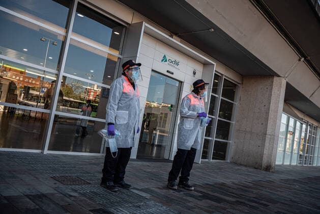 April 14, 2020, Girona, Spain: Members of Civic Agents of Girona wait outside the Girona train station to offer protection masks to the passengers during the the first day of work after the lift of the lock down restriction..Some industries and construction sectors in Catalonia resume work as the lockdown restrictions have been changed. Health Ministry of Spain has so far recorded a total of 170,099 infections, 17,756 death and 64,727 recovered since the beginning of the corona virus outbreak. Girona Spain - ZUMAs197 20200414_zaa_s197_056 Copyright: xAdriÃ xSalidoxZarcox