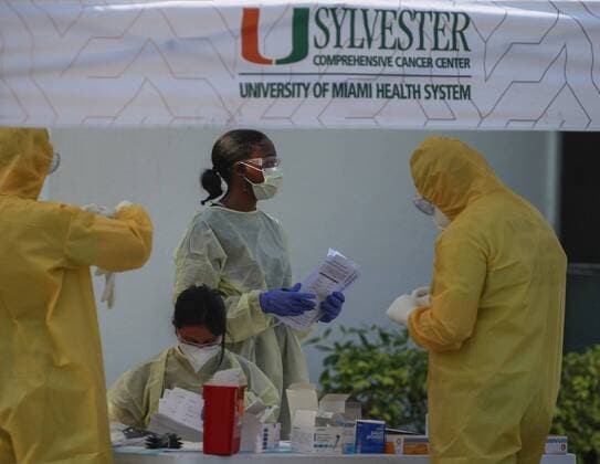 April 14, 2020, Miami, FL, USA: On Tuesday, April 14, 2020 a team of University of Miami Health Systems medical workers and members of Miami-Dade Ocean Rescue check appointments and took blood samples as vehicles lined up for COVID-19 screening at the Lemon City Library in Little Haiti. Miami USA - ZUMAm67_ 20200414_zaf_m67_012 Copyright: xCarlxJustex