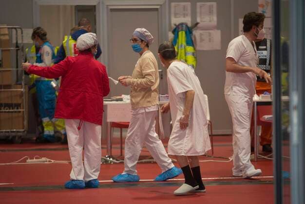 Coronavirus Outbreak COVID 19 Health workers and a patient at the temporary field hospital for coronavirus patients installed at the IFEMA Fairgrounds of Madrid to unload the saturation on hospitals because to the COVID 19 pandemic Photo by Jose Cuesta 261 Cordon Press  JosexCuesta