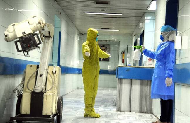 (200414) -- DAMASCUS, April 14, 2020 -- A medical worker gets disinfected in an isolation unit at the Mujtahid hospital in Damascus, capital of Syria, on April 14, 2020. Four new COVID-19 cases were reported in Syria on Tuesday, bringing the overall number of registered cases to 29, the health ministry said in a statement. (Photo by Xinhua) SYRIA-DAMASCUS-COVID19-HOSPITAL AmmarxSafarjalani 