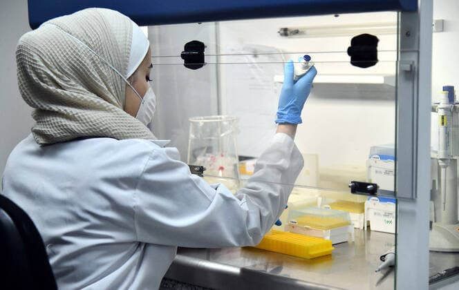 (200414) -- DAMASCUS, April 14, 2020 -- A laboratorian works on a test for COVID-19 virus at a laboratory in Damascus, capital of Syria, on April 14, 2020. Four new COVID-19 cases were reported in Syria on Tuesday, bringing the overall number of registered cases to 29, the health ministry said in a statement. (Photo by Xinhua) SYRIA-DAMASCUS-COVID19-TEST AmmarxSafarjalani 