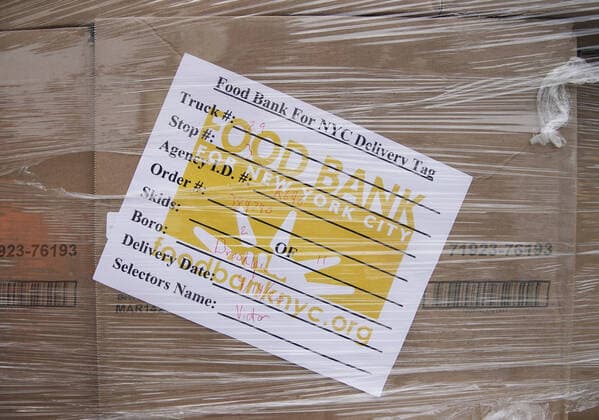 Boxes of packaged labeled food bank for New York City is stacked on the sidewalk when New York Mayor Bill de Blasio speaks to workers when he visits The Campaign Against Hunger food pantry in New York City on Tuesday, April 14, 2020. As of today nearly 285,000 have been infected and more than 14,000 people have died in NY, NJ and CT. There are signs however that the curve is flattening.  NYP20200414104 JOHNxANGELILLO