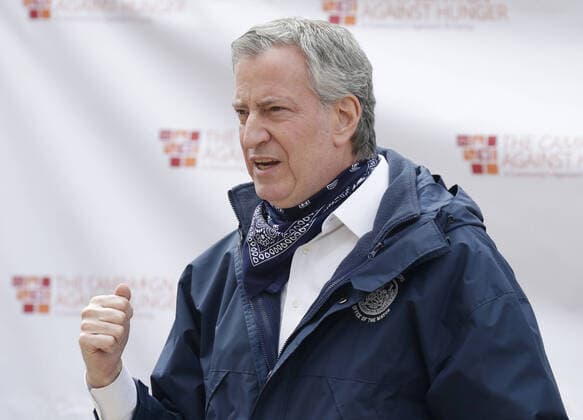 New York Mayor Bill de Blasio speaks to workers when he visits The Campaign Against Hunger food pantry in New York City on Tuesday, April 14, 2020. As of today nearly 285,000 have been infected and more than 14,000 people have died in NY, NJ and CT. There are signs however that the curve is flattening.  NYP20200414108 JOHNxANGELILLO