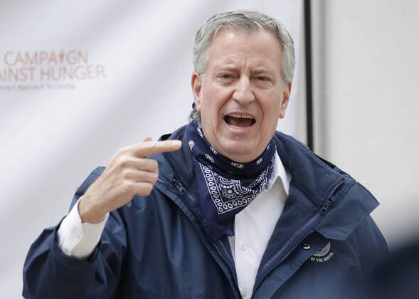 New York Mayor Bill de Blasio speaks to workers when he visits The Campaign Against Hunger food pantry in New York City on Tuesday, April 14, 2020. As of today nearly 285,000 have been infected and more than 14,000 people have died in NY, NJ and CT. There are signs however that the curve is flattening.  NYP20200414109 JOHNxANGELILLO