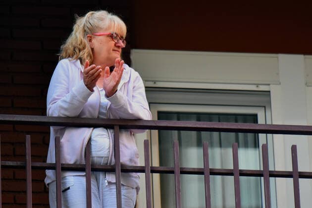 April 14, 2020, LÂ Hospitalet, Barcelona, Spain: A woman applauds Covid-19 fighters from her terrace during confinement..Citizens of LÂ Hospitalet at 8:00 pm continue to applaud showing gratitude to the people who are struggling in the fight against the Covid-19 health crisis, they give each other hope. LÂ Hospitalet Spain - ZUMAs197 20200414_zaa_s197_118 Copyright: xRamonxCostax