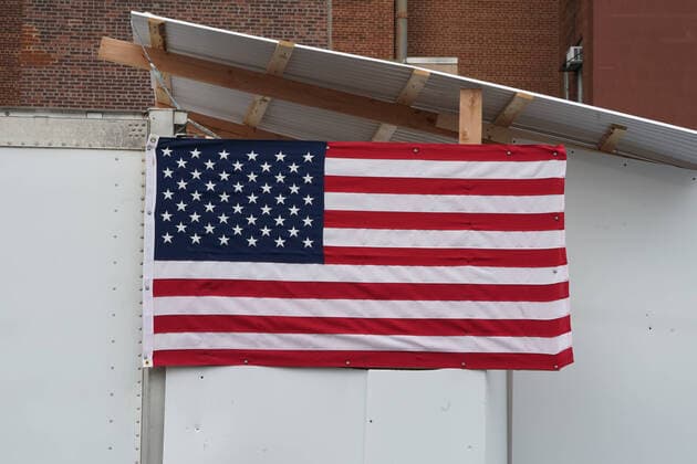 April 14, 2020, New York, NY, USA: An American flag hangs from a refrigeration truck serving as a temporary morgue outside Wyckoff Heights Medical Center in the Borough of Brooklyn on April 14, 2020 in New York. New York USA - ZUMAb148 20200414_zap_b148_013 Copyright: xBryanxSmithx