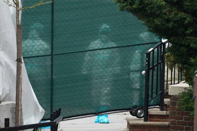 April 14, 2020, New York, NY, USA: Medical workers behind a screen working at a refrigeration trailer serving as a temporary morgue outside of Brooklyn Hospital Center in the Borough of Brooklyn on April 14, 2020 in New York. New York USA - ZUMAb148 20200414_zap_b148_021 Copyright: xBryanxSmithx