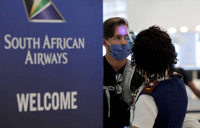April 14, 2020, Miami, FL, USA: Rosemary Arends, an assistant nurse-flight attendant, checks the temperature of passengers and then helps a group of South African nationals at Miami International Airport boarding a special charter flight by South African Airways on Tuesday, April 14, 2020. Amid the coronavirus pandemic, the flight will repatriate more than 300 South African workers who were supposed to spend these months working at South Florida hotels and resorts. Miami USA - ZUMAm67_ 20200414_zaf_m67_034 Copyright: xPedroxPortalx