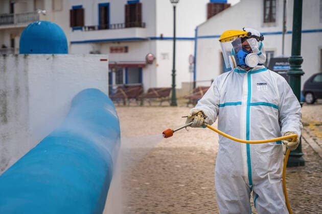 April 14, 2020, Ericeira, Portugal: An employee of the Ericeira parish council, equipped with the recommended protective materials, disinfects the street with a solution based on hypochlorite (bleach)..The municipality of Mafra had 70 cases of COVID-19 pandemic. In order to prevent the spread of the virus, the Ericeira Parish Council perform weekly street disinfection. Ericeira Portugal - ZUMAs197 20200414_zaa_s197_180 Copyright: xHenriquexCasinhasx