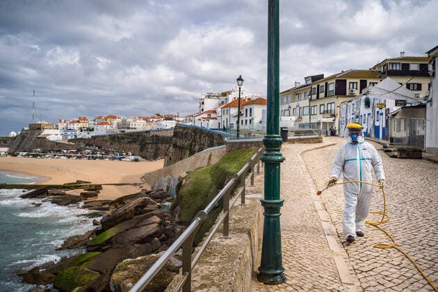 April 14, 2020, Ericeira, Portugal: An employee of the Ericeira parish council, equipped with the recommended protective materials, disinfects the street with a solution based on hypochlorite (bleach)..The municipality of Mafra had 70 cases of COVID-19 pandemic. In order to prevent the spread of the virus, the Ericeira Parish Council perform weekly street disinfection. Ericeira Portugal - ZUMAs197 20200414_zaa_s197_186 Copyright: xHenriquexCasinhasx