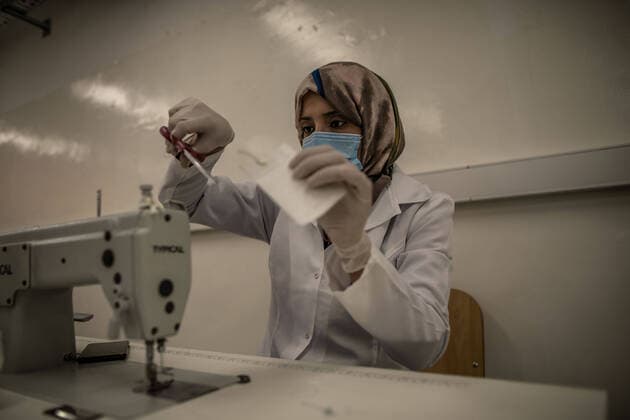 (200415) -- TRIPOLI, April 15, 2020 (Xinhua) -- A worker makes protective suits in a fashion school which was turned into a workshop producing protective gears in Tripoli, Libya, on April 14, 2020. The Libyan National Center for Disease Control on Tuesday announced nine new COVID-19 cases, bringing the total number of confirmed cases in the country to 35. (Photo by Amru Salahuddien Xinhua) LIBYA-TRIPOLI-COVID-19-PROTECTIVE WORKSHOP 