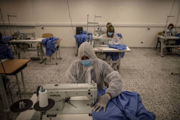 (200415) -- TRIPOLI, April 15, 2020 (Xinhua) -- Workers make protective suits in a fashion school which was turned into a workshop producing protective gears in Tripoli, Libya, on April 14, 2020. The Libyan National Center for Disease Control on Tuesday announced nine new COVID-19 cases, bringing the total number of confirmed cases in the country to 35. (Photo by Amru Salahuddien Xinhua) LIBYA-TRIPOLI-COVID-19-PROTECTIVE WORKSHOP 