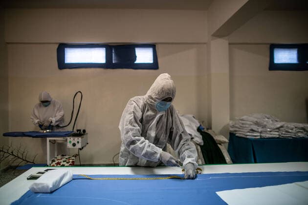 (200415) -- TRIPOLI, April 15, 2020 (Xinhua) -- A worker cuts fabric to make protective suits in a fashion school which was turned into a workshop producing protective gears in Tripoli, Libya, on April 14, 2020. The Libyan National Center for Disease Control on Tuesday announced nine new COVID-19 cases, bringing the total number of confirmed cases in the country to 35. (Photo by Amru Salahuddien Xinhua) LIBYA-TRIPOLI-COVID-19-PROTECTIVE WORKSHOP 