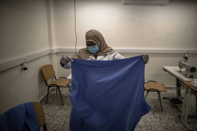(200415) -- TRIPOLI, April 15, 2020 (Xinhua) -- A worker prepares fabric to make protective suits in a fashion school which was turned into a workshop producing protective gears in Tripoli, Libya, on April 14, 2020. The Libyan National Center for Disease Control on Tuesday announced nine new COVID-19 cases, bringing the total number of confirmed cases in the country to 35. (Photo by Amru Salahuddien Xinhua) LIBYA-TRIPOLI-COVID-19-PROTECTIVE WORKSHOP 