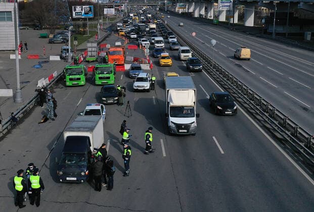 MOSCOW, RUSSIA - APRIL 15, 2020: A traffic congestion at a checkpoint on Leningradskoye Shosse Motorway at the entrance to Moscow during the pandemic of the novel coronavirus disease (COVID-19). Traffic police have set up checkpoints around the city to stop vehicles and see if drivers have permission to travel during the lockdown. On 13 April 2020, the Moscow government introduced a digital permit system aimed at further restricting movement. Under the new scheme, which becomes mandatory from 15 April, people need to apply for permits to travel on a vehicle or public transport around the city. Earlier, on 11 April, the Moscow government restricted vehicles registered outside Moscow Region from entering the Russian capital. Since 30 March 2020, Moscow has been on lockdown. As of 15 April 2020, Russia has reported more than 21,100 confirmed TS0D5CD9