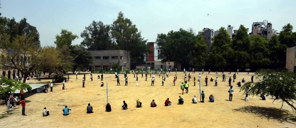 NEW DELHI, INDIA - APRIL 15: Stranded migrant workers and homeless people queue to collect food during the lockdown, at Sunlight colony, Seema Puri area on April 15, 2020 in New Delhi, India. (Photo by Sonu Mehta Hindustan Times) India Extends Nationwide Coronavirus Lockdown Until May 3