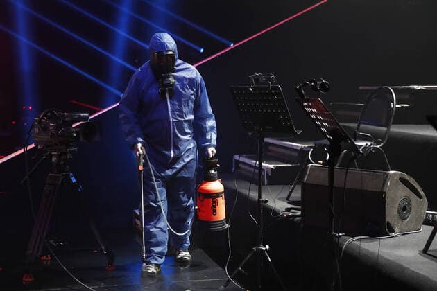 MOSCOW, RUSSIA - APRIL 16, 2020: A worker in a protective suit disinfecting the studio of The Voice Kids Russia reality TV singing competition ahead of a live broadcast scheduled for April 17; the shooting will be held without spectators and with the fewest possible members of the crew. Artyom Geodakyan TASS  TS0D60E4