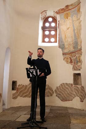 LENINGRAD REGION, RUSSIA - APRIL 19, 2020: Mariinsky Theatre soloist, operatic baritone singer Vladimir Tselebrovsky, gives an online Easter concert at St George s Church of the ancient Ladoga fortress at the Staraya Ladoga Museum Reserve on the Volkhov River near Lake Ladoga. Patriarch Kirill of Moscow and All Russia urged believers to celebrate Easter at home and watch liturgies broadcasted on TV amid the ongoing COVID-19 coronavirus pandemic. Peter Kovalev TASS  TS0D65DA