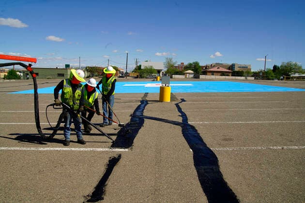 News Bilder des Tages April 19, 2020, Albuquerque, NEW MEXICO, USA: 041920 ..A Sunland Asphalt crew seals cracks in the parking lot of Milne Stadium in Southeast Albuquerque. The site will be used as a Heliport to transport Covid- 19 patients to Presbyterian Hospital..Photographed on Sunday April 19, 2020.Adolphe Pierre-LouisJournal. Albuquerque USA - ZUMAab1_ 20200419_zaf_ab1_004 Copyright: xAlbuquerquexJournalx