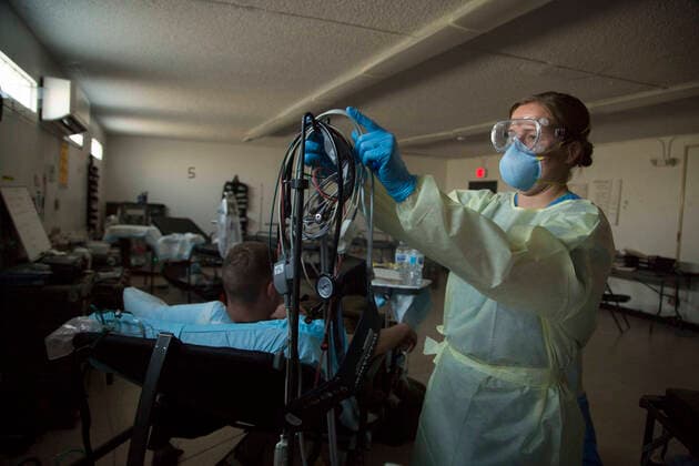 April 14, 2020, Apra Harbor, Guam, United States: U.S. Navy sailor Lt. Caroline Kivisto, a nurse assigned to 3rd Medical Battalion, adjusts equipment during a 48-hour observation for COVID-19, coronavirus infection on a sailor assigned to aircraft carrier USS Theodore Roosevelt at Naval Base Guam April 14, 2020 in Apra, Guam. Apra Harbor United States - ZUMAp138 20200414_zaa_p138_039 Copyright: xJordanxE.xGilbert NationalxGuardx