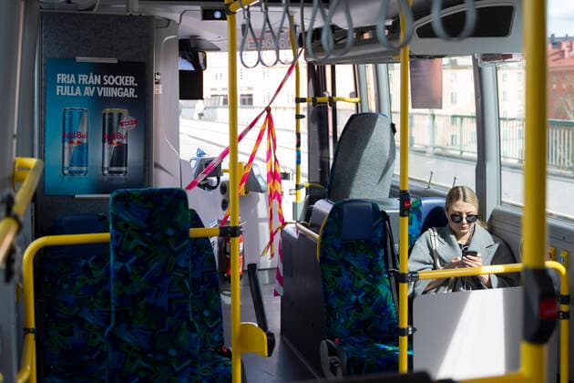 A woman uses her mobile phone on a local bus in Stockholm, Sweden, on April 20, 2020 The drivers area at the front door is cordoned off, and commuters have to enter the bus through the back doors to to protect bus drivers from the coronavirus Covid 19 STOCKHOLM SWEDEN x11950x,  Copyright: xAlixLorestani TTx SWEDEN DAILY LIFE CORONA