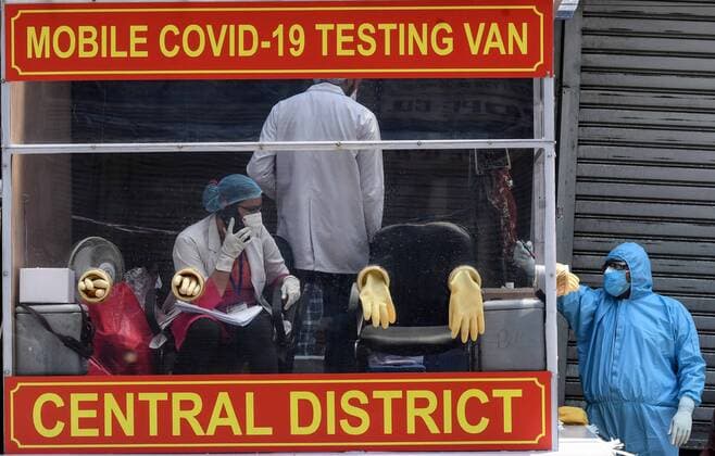 NEW DELHI, INDIA - APRIL 21: Health workers in a mobile testing van before taking swab samples from residents of the Hauz Qazi area for COVID-19 antibody rapid testing as a precautionary measure during lockdown on April 21, 2020 in New Delhi, India. (Photo by Biplov Bhuyan Hindustan Times) Antibody Rapid Testing In Delhi In View Of Covid-19 Pandemic